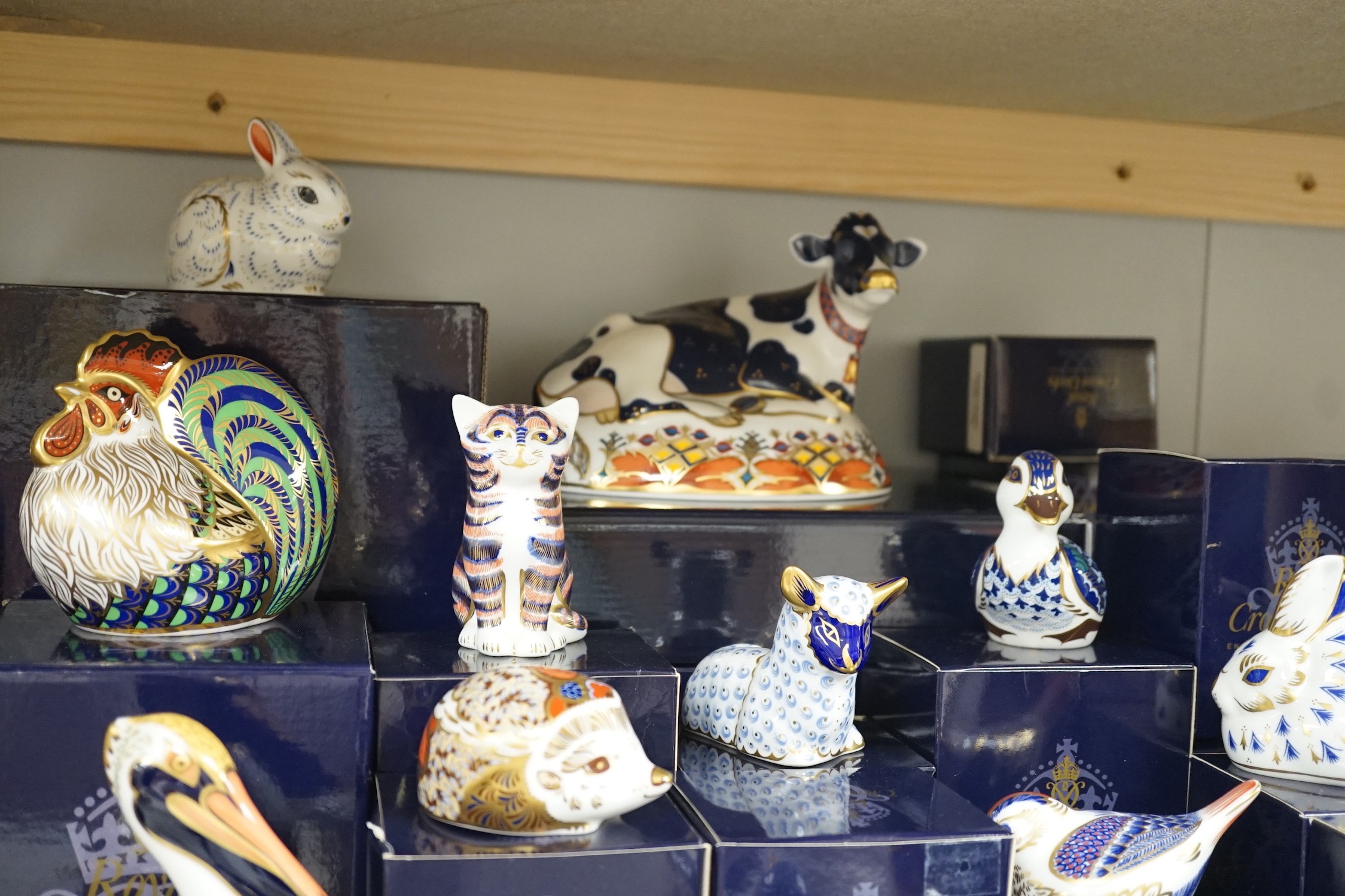 Approximately thirty-two Royal Crown Derby Imari porcelain paperweights, all but two with original boxes and mostly gold bottoms
